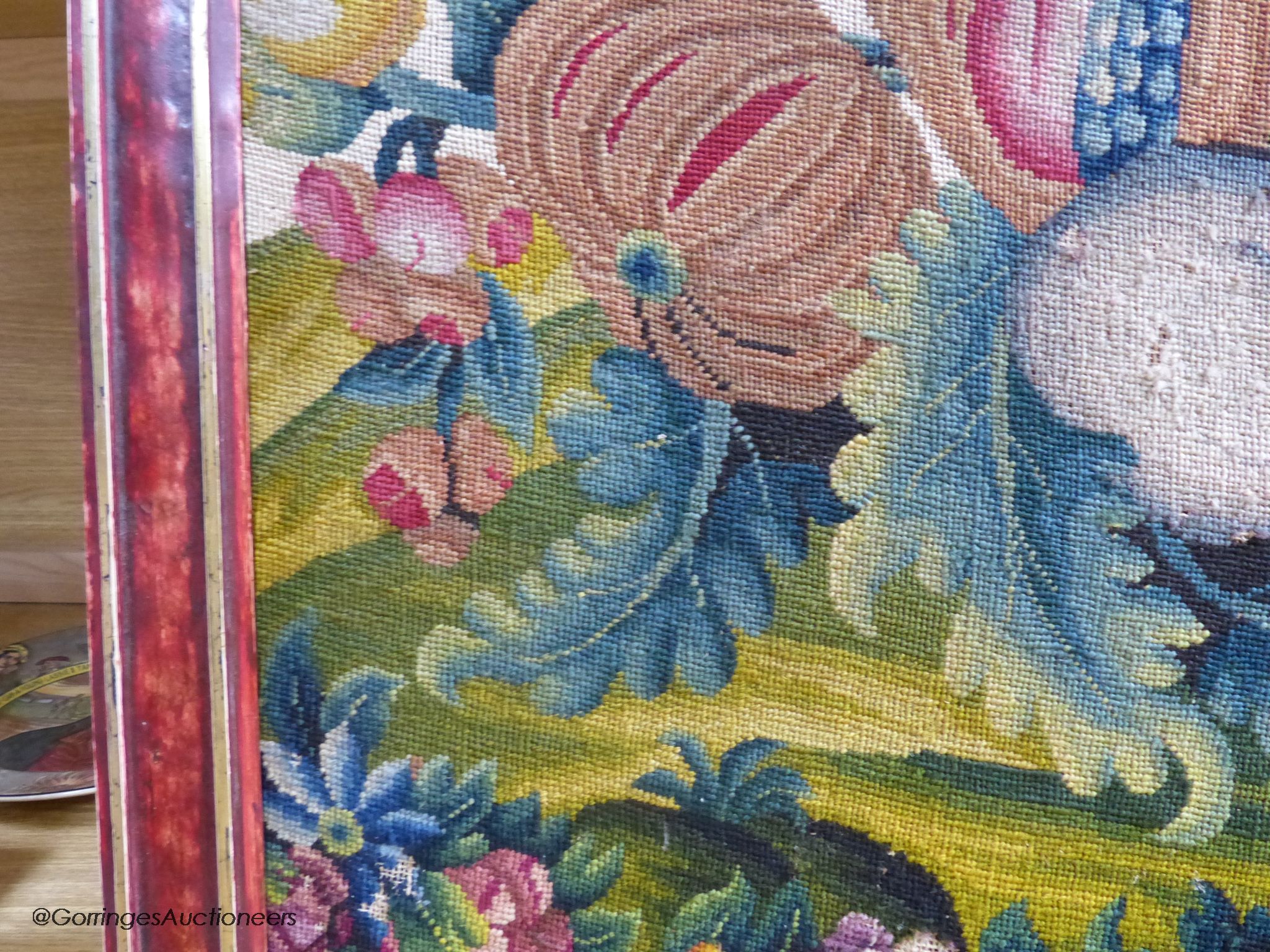 A framed 19th century woolwork panel depicting pomegranates, other fruit and flowers, 71 x 38cm